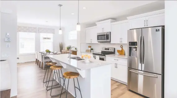  ?? PHOTOS: STEPPER HOMES ?? The kitchen in the Mckinney townhome show home by Stepper Homes in Wolf Willow boasts a functional cooking space with an elegant full-height backsplash.