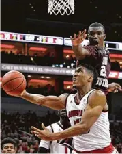  ?? Timothy D. Easley / Associated Press ?? Texas Southern’s Derrick Griffin, who had 26 rebounds, puts pressure on Louisville’s Donovan Mitchell, who goes in for a layup in the second half.