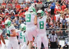  ?? JAY LAPRETE/ASSOCIATED PRESS ?? Oregon tight end Moliki Matavao, right, celebrates his touchdown against Ohio State with tight end Terrance Ferguson during the second half on Saturday. Oregon beat Ohio State 35-28.