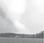  ?? COURTESY OF JULIE ALDRICH ?? A tornado moves through Windham, Ohio on Wednesday evening.