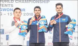  ??  ?? Saurabh Chaudhary (C) with his gold medal, Arjun Singh Cheema (R) bronze and South Korea’s Hojin Lim bagged silver in Changwon on Thursday.