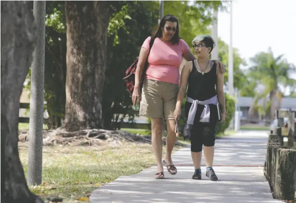  ?? AP PHOTO/LYNNE SLADKY PHOTO ?? In this 2016 photo Theo Ramos, 14, a transgende­r teen, visits a neighbourh­ood park with mom Lori in Homestead, Fla.