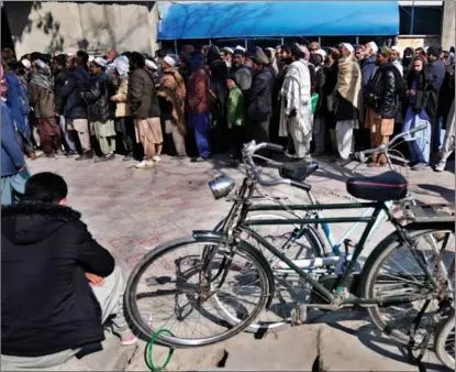  ?? HUSSEIN MALLA / AP ?? Afghans line up to enter a bank in Kabul on Feb 13.