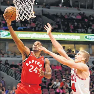  ?? AP PHOTO ?? Toronto Raptors guard Norman Powell (left) shoots past Chicago Bulls forward Lauri Markkanen during NBA preseason action Oct. 13 in Chicago.