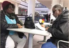  ?? (Katanga Johnson/Reuters) ?? GRAILING AND Joyce Carter review their property taxes at the Fairfax County Department of Tax Administra­tion Office in Fairfax, Virginia, last Thursday.