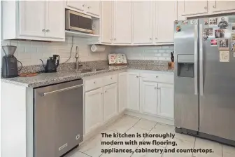  ??  ?? The kitchen is thoroughly modern with new flooring, appliances, cabinetry and countertop­s.