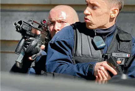  ?? PHOTO: REUTERS ?? Police patrol outside the Internatio­nal Monetary Fund offices where an envelope exploded in Paris.