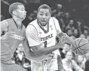  ?? AP ?? Temple's Khalif Wyatt (right) drives against Syracuse's Michael Carter-Williams during the first half of Saturday’s game. Wyatt scored 33 points as the Owls shocked the Orange.