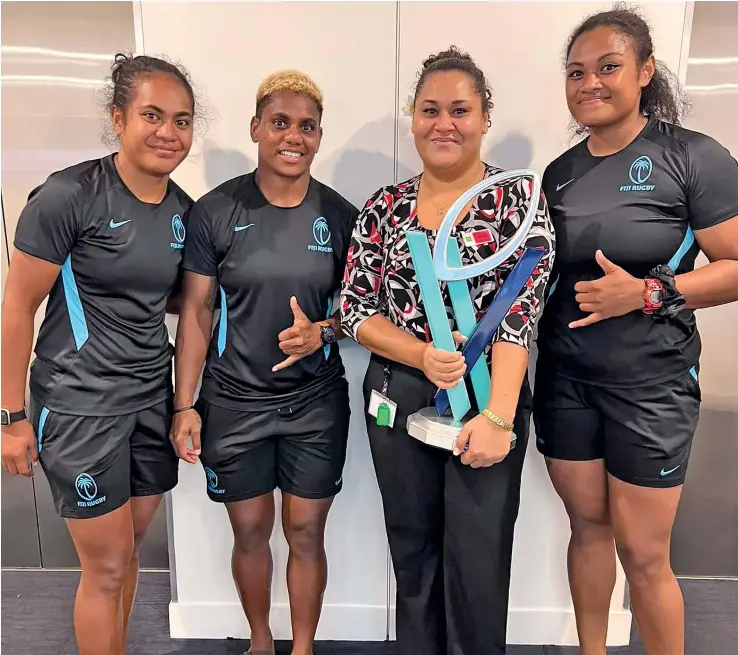  ?? Photo: Supplied ?? Rooster Chicken Fijiana players, from left, Younis Bese, Roela Radiniyavu­ni, Octavia Rose Wilson (sister of Fijiana 15s player Talei Wilson) and Asinate Serevi with the Super W trophy.