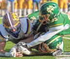  ?? ?? Newark Catholic players, including Michael Hess (35) and Chance Brooks (44), dive trying to recover a fumble.