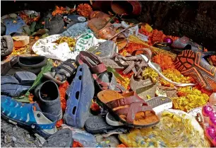  ?? — Reuters ?? Footwear of the victims of the stampede are seen below pedestrian overbridge in Mumbai.