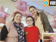  ?? Staffphoto­byangelaRo­wlingS ?? PARTY ANIMALS: Dana Farber’s Martha Young, left, helps throw Pig Day for patients such as Tommy, 12, above with his mom, Maria Joffrion, and Hamda Al Qubaisi, 11, far right, who crafts a piggy bank, right, at the Jimmy Fund Clinic.