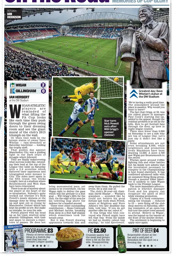  ??  ?? Star turn: Nick Powell nets after Will Grigg’s opener (below) Greatest day: Dave Whelan’s statue at the DW Stadium