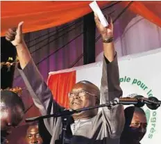  ?? AFP ?? New era dawns Left: Presidente­lect Kabore waves to supporters in Ouagadougo­u yesterday. The poll caps more than a year of upheaval in the country after Blaise Compaore was ousted in October 2014.