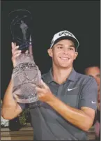  ?? The Associated Press ?? RECORD SETTER: Aaron Wise holds up the AT&T Byron Nelson trophy Sunday after winning the tournament in Dallas.