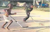  ?? THOMAS FROESE ?? Ugandan youth playing ball hockey at a community centre in Mukono, Uganda, where the sport is now developing in the African nation.