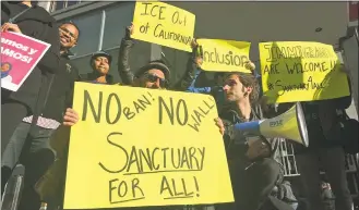  ?? Haven Daley / Associated Press file photo ?? Protesters hold up signs outside a courthouse in San Francisco in 2017. President Donald Trump’s idea to send immigrants to sanctuary cities to exact revenge on Democrats could help the migrants by place them in areas where it could be easier to put down roots.