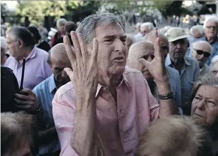  ?? ARIS MESSINIS/AFP/GETTY IMAGES ?? Pensioners queue outside an Athens bank Wednesday as they attempt to withdraw up to 120 euros ($167) against their monthly pension payment.