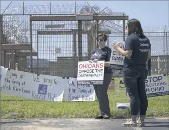  ?? Adam Cairns/The Columbus Dispatch via AP ?? Samantha Searls of Cincinnati stands with other protestors outside the Southern Ohio Correction­al Facility in Lucasville, Ohio on Wednesday following the execution of Ronald Phillips for aggravated murder, felonious sexual penetratio­n and rape. Ms....