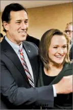  ?? JOHN GRESS/REUTERS PHOTO ?? Former Pennsylvan­ia Sen. Rick Santorum celebrates with his wife, Karen, as they react to voting results Tuesday in Johnston, Iowa.