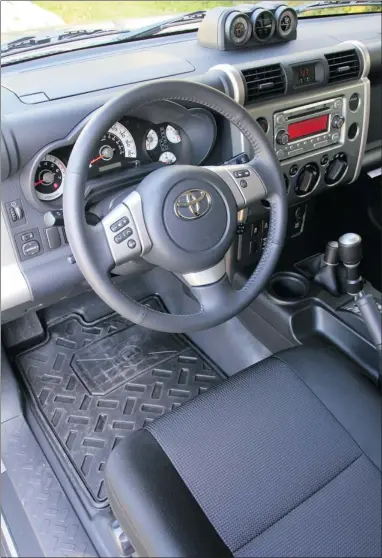 ??  ?? The FJ’s dash has a utilitaria­n, industrial look with plain white-faced gauges that are easy to read.