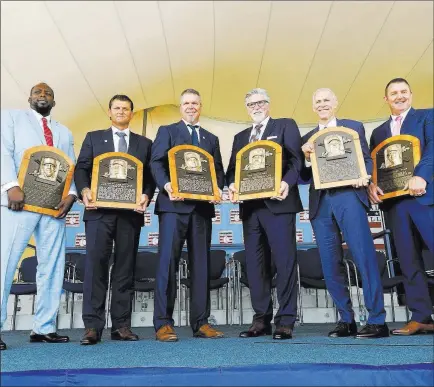  ?? Hans Pennink ?? The Associated Press Baseball Hall of Famers, from left, Vladimir Guerrero, Trevor Hoffman, Chipper Jones, Jack Morris, Alan Trammell, and Jim Thome hold their plaques after their induction ceremony Sunday in Cooperstow­n, N.Y.