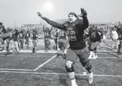  ?? ?? Offensive lineman Dawson Keir rushes to celebreate UIW’s overtime victory over SFA with fans.