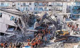  ?? BULENT KILIC/GETTY-AFP ?? Rescue workers on Sunday search for victims and survivors amid the rubble of a building two days after a powerful earthquake struck Elazig, Turkey.