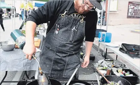  ?? LANCE ANDERSON PETERBOROU­GH THIS WEEK ?? Tyler Scott, from Rare Grill House, competes in the Iron Chef Market Cook Off Challenge at the Downtown Farmers’ Market on Wednesday. Scott, the returning champion, ended up winning the event for the second time in a row.