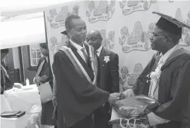  ??  ?? Staff Sergeant Francis Shamu of One Medical Company receives a gift for being first runner up in the Crop Husbandry Course at a Zimta Ehlekwini Vocation Institute from Zimta secretary general Mr Tapson Nganunu Sibanda. Fourteen army officers drawn from...
