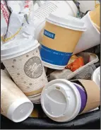  ??  ?? Overflowin­g: A bin full of coffee cups