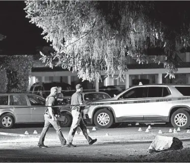  ?? TED WARREN/AP ?? Police at the scene after activist Michael Reinoehl was shot to death by a federal task force Sept. 3 in Lacey, Washington.