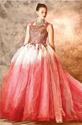 ??  ?? Red ball gown with monochroma­tic red skirt and beaded top.