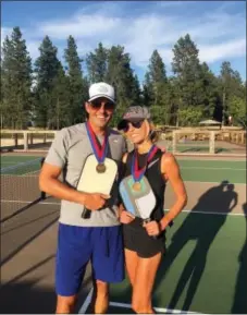  ?? GIULIANA RANCIC VIA AP ?? Bill and Giuliana Rancic pose for a photo in Harrison, Idaho after winning a Mixed Doubles Pickleball Tournament. It’s tempting to blow off a workout, but getting sweaty with your significan­t other makes a workout more fun and ups the intensity ante.