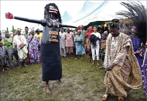  ?? UTOMI EKPEI/AFP PIUS ?? A man dances with a wooden figure during the Igbo-Ora World Twins festival at Igbo-Ora town in Oyo State, southwest Nigeria on Saturday.