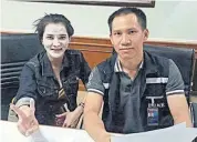  ??  ?? A photo taken at Mae Sai immigratio­n office shows Preaw with a face mask flashing the victory sign next to an official.