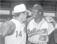  ?? AP FILE ?? During spring training in 1966, baseball’s all-time hits leader Pete Rose of Cincinnati, left, yuks it up with Baltimore’s Frank Robinson. That offseason, the Reds traded Robinson to the Orioles.