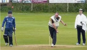  ??  ?? Rick Booth, a supporter of the Bone Cancer Charity, bowling for a Marple side last Sunday at Bowden Lane