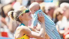  ??  ?? Claire Tallent with son Harvey at the world championsh­ips.