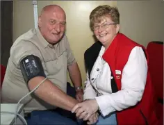 ??  ?? Declan O’Neill of Wexford Working Men’s Shed has his blood preasure checked by Janice Stephenson, Irish Heart Foundation.
