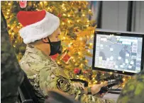  ?? SABLE BROWN/ASSOCIATED PRESS FILE PHOTO ?? A service member shows how Santa is tracked during a media preview at the Canadian Forces Base in North Bay, Ontario, earlier this month. The wildly popular joint U.S.-Canadian Christmas tradition is now in its 66th year.