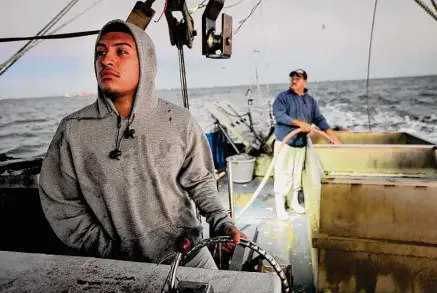  ?? Jon Shapley/Staff photograph­er ?? Adrian Gutierrez and his dad, Alex, fish for shrimp in October in Galveston Bay. Shrimping helps them get by in the offseason.