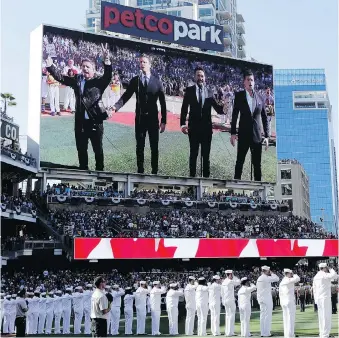  ?? BULL/THE ASSOCIATED PRESS FILES GREGORY ?? The Tenors, seen on the scoreboard, sing the Canadian national anthem prior to the MLB all-star game.