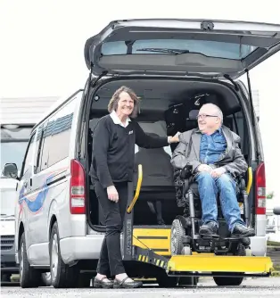  ?? PHOTO: PETER MCINTOSH ?? Access issues . . . Southern City Taxis driver Julie Manson helps Chris Ford in to one of the company’s total mobility taxis.