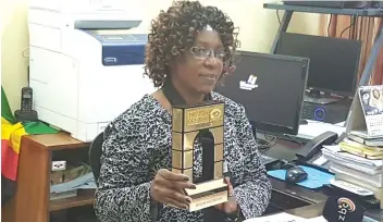  ??  ?? Mutare Poly Principal Mrs Poniso Watema shows off one of the accolades.