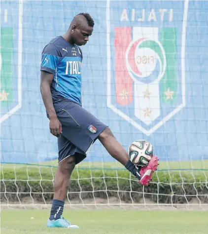  ?? Antonio Calanni/THE ASSOCIATED PRESS ?? Italian striker Mario Balotelli controls the ball during a training session this week in Mangaratib­a, Brazil.