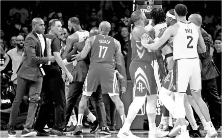  ??  ?? Chris Paul #3 of the Houston Rockets is restrained by LeBron James #23 of the Los Angeles Lakers after a fight involving Rajon Rondo #9 and Brandon Ingram #14 of the Los Angeles Lakers during a 124-1115 Rockets win at Staples Center on October 20, 2018 in Los Angeles, California. — AFP