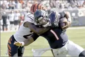  ?? AP photo ?? Bears quarterbac­k Justin Fields is tackled by Bengals cornerback Chidobe Awuzie on Sunday.