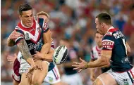  ?? GETTY IMAGES ?? Sonny Bill Williams offloads to James Maloney for the Roosters in the NRL in 2013. The pair will be opponents in Super League in 2020.