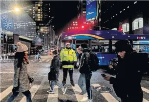  ?? JEENAH MOON THE NEW YORK TIMES ?? Preston Martin works as a pedestrian safety manager — a crossing guard for grown-ups — on Varick St. at the Holland Tunnel, one of Manhattan’s worst traffic choke points.